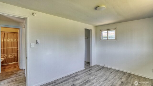 4821 101st St SW, Lakewood, WA 98499 - empty room with light wood-style floors and baseboards