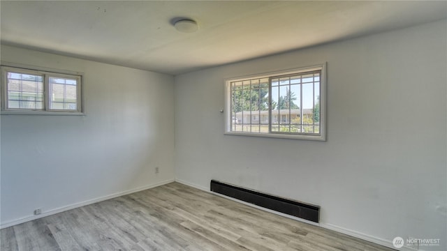 4821 101st St SW, Lakewood, WA 98499 - spare room featuring a baseboard heating unit, wood finished floors, and baseboards