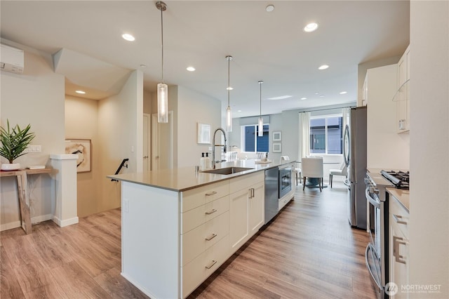 2349 N 147th St Unit B, Shoreline, WA 98133 - kitchen featuring a sink, stainless steel appliances, an island with sink, white cabinets, and recessed lighting