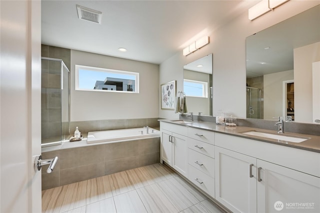 2349 N 147th St Unit B, Shoreline, WA 98133 - full bath featuring double vanity, a stall shower, a garden tub, tile patterned flooring, and recessed lighting