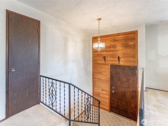604 N Larch Ave, East Wenatchee, WA 98802 - stairway with carpet, a textured ceiling, and wood walls