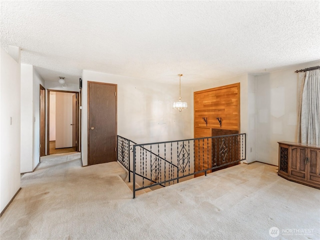 604 N Larch Ave, East Wenatchee, WA 98802 - corridor featuring an upstairs landing, carpet, and a textured ceiling