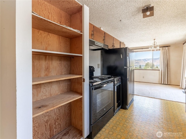 604 N Larch Ave, East Wenatchee, WA 98802 - kitchen with black range with electric cooktop, under cabinet range hood, a textured ceiling, a chandelier, and brown cabinets