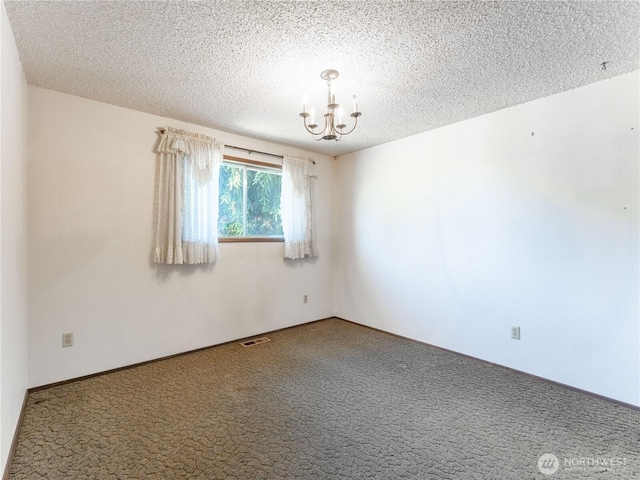 604 N Larch Ave, East Wenatchee, WA 98802 - carpeted empty room with a chandelier and a textured ceiling