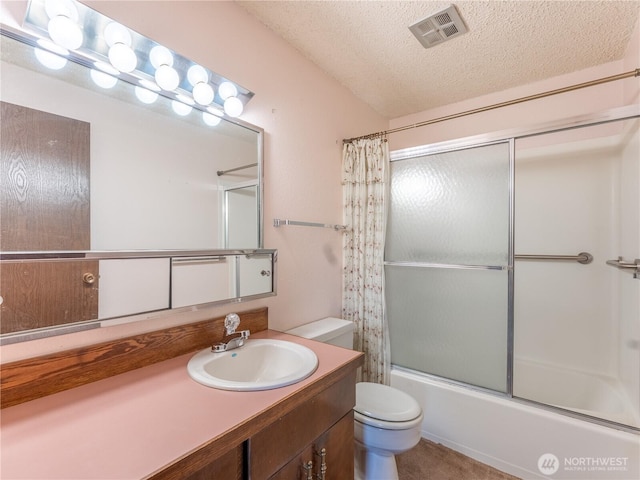 604 N Larch Ave, East Wenatchee, WA 98802 - bathroom with toilet, a textured ceiling, vanity, enclosed tub / shower combo, and lofted ceiling