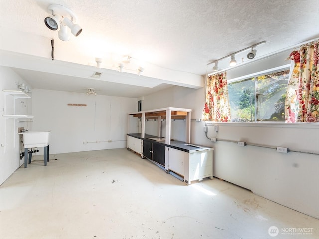 604 N Larch Ave, East Wenatchee, WA 98802 - interior space with concrete flooring, a textured ceiling, and a sink