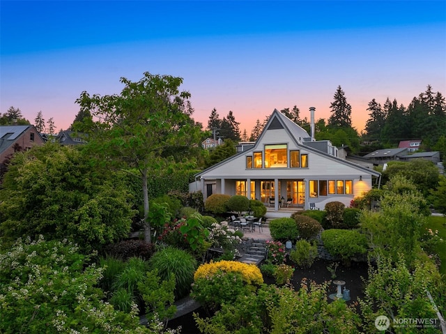 1237 Hawley Way NE, Bainbridge Island, WA 98110 - back of house at dusk with covered porch