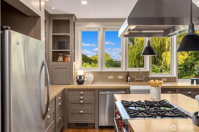 1237 Hawley Way NE, Bainbridge Island, WA 98110 - kitchen featuring stainless steel appliances, island range hood, light countertops, healthy amount of natural light, and recessed lighting