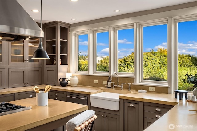 1237 Hawley Way NE, Bainbridge Island, WA 98110 - kitchen featuring island exhaust hood, light countertops, recessed lighting, glass insert cabinets, and gray cabinetry