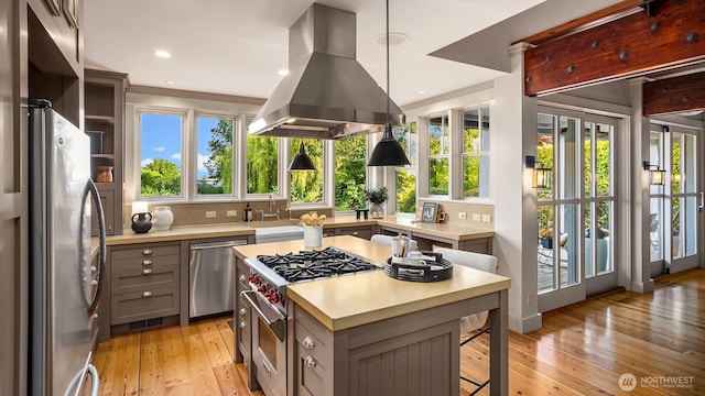 1237 Hawley Way NE, Bainbridge Island, WA 98110 - kitchen featuring island range hood, appliances with stainless steel finishes, gray cabinets, light wood-type flooring, and recessed lighting