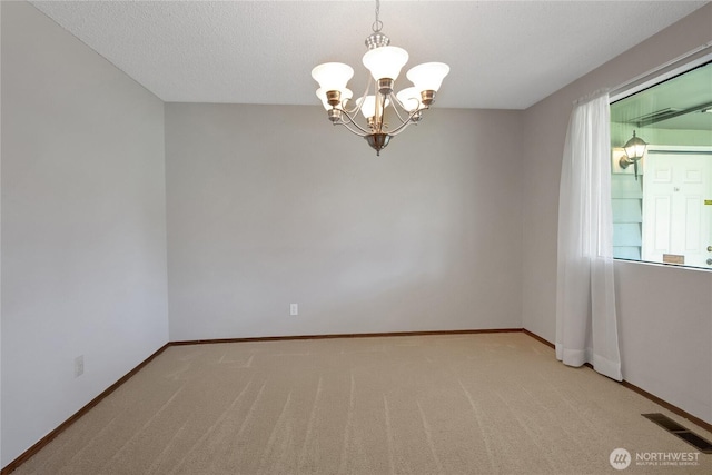 10202 Pipeline Rd E, Puyallup, WA 98373 - spare room featuring a chandelier, carpet floors, and baseboards