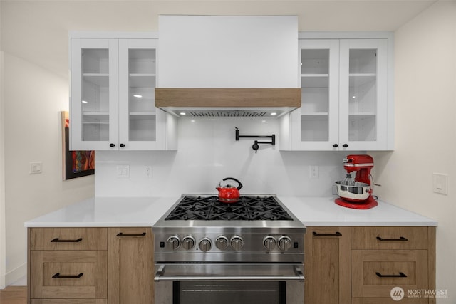 7201 Seward Park Ave S, Seattle, WA 98118 - kitchen featuring high end stainless steel range oven, custom exhaust hood, white cabinets, and light countertops
