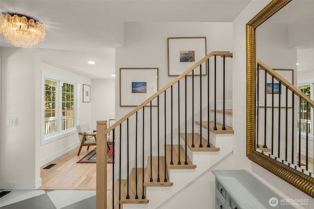 7201 Seward Park Ave S, Seattle, WA 98118 - staircase with a chandelier, baseboards, and recessed lighting