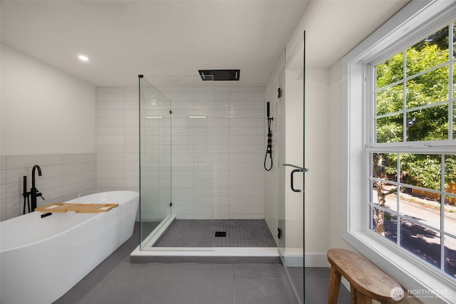 7201 Seward Park Ave S, Seattle, WA 98118 - bathroom featuring a shower stall, tile patterned floors, a freestanding tub, tile walls, and recessed lighting