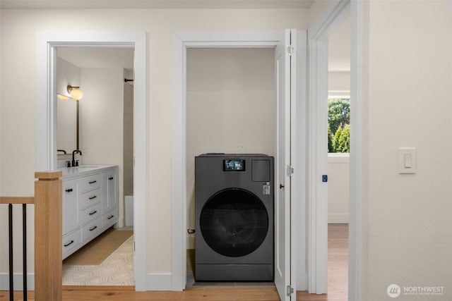 7201 Seward Park Ave S, Seattle, WA 98118 - laundry area featuring washer / dryer, light wood-type flooring, and baseboards