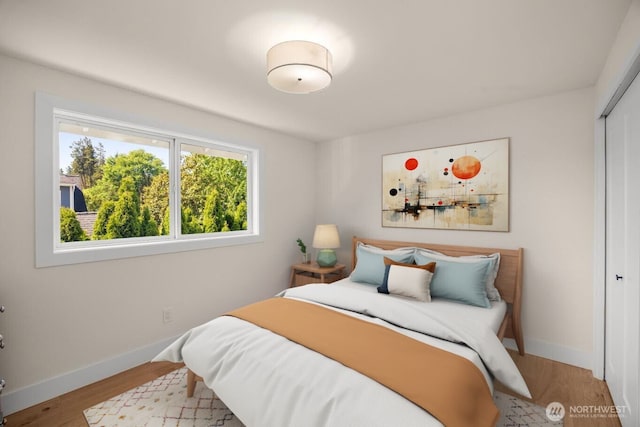 7201 Seward Park Ave S, Seattle, WA 98118 - bedroom with a closet, baseboards, and wood finished floors