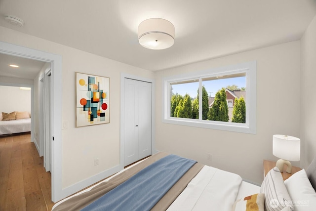 7201 Seward Park Ave S, Seattle, WA 98118 - bedroom featuring hardwood / wood-style flooring, a closet, and baseboards