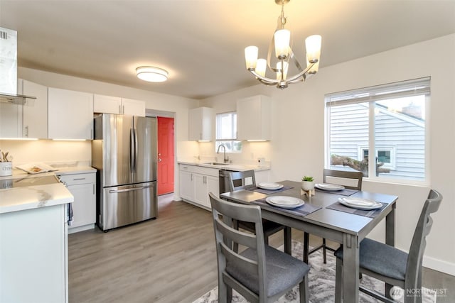 2914 S 17th St, Tacoma, WA 98405 - dining area featuring a chandelier and light wood finished floors