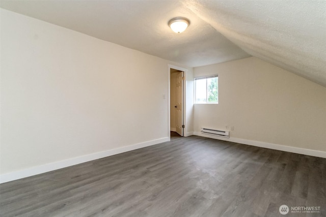 2914 S 17th St, Tacoma, WA 98405 - bonus room featuring a baseboard heating unit, dark wood finished floors, lofted ceiling, baseboards, and a textured ceiling