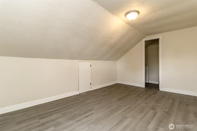 2914 S 17th St, Tacoma, WA 98405 - additional living space featuring a textured ceiling, vaulted ceiling, wood finished floors, and baseboards