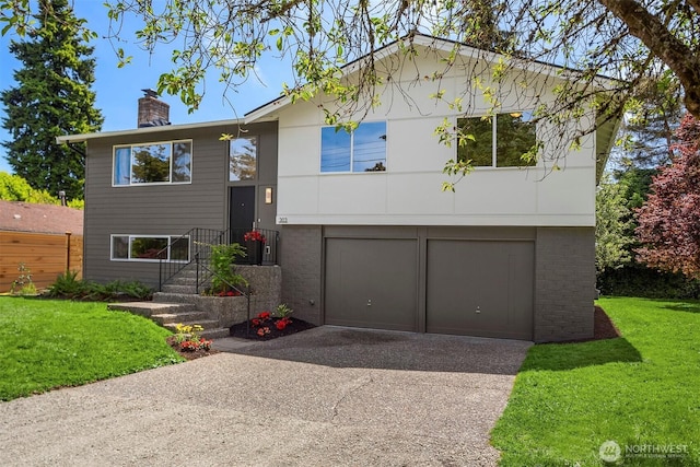 303 NE 133rd St, Seattle, WA 98125 - split foyer home featuring driveway, a chimney, an attached garage, and a front yard