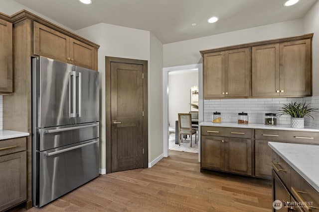 1794 Granite Way SE, North Bend, WA 98045 - kitchen with freestanding refrigerator, light wood-style floors, light countertops, decorative backsplash, and recessed lighting