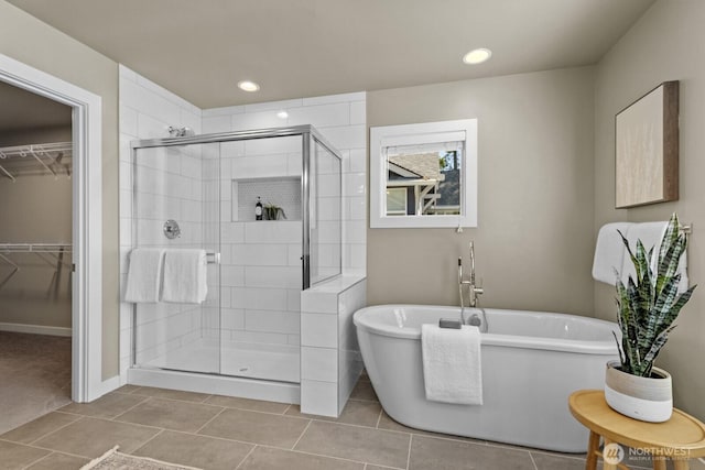 1794 Granite Way SE, North Bend, WA 98045 - bathroom featuring a stall shower, a freestanding bath, a walk in closet, tile patterned floors, and recessed lighting