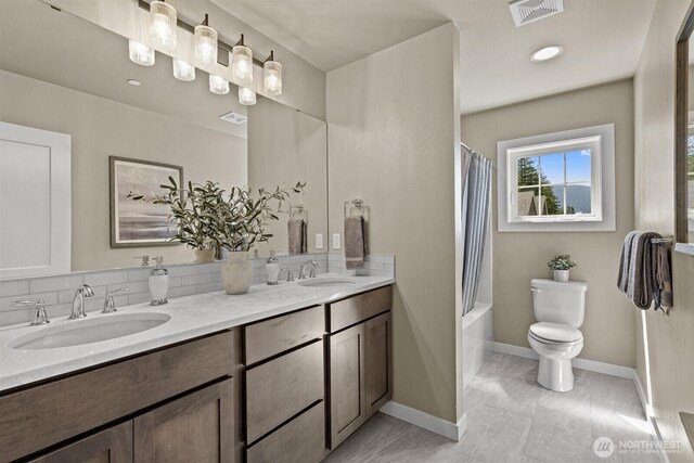 1794 Granite Way SE, North Bend, WA 98045 - bathroom featuring double vanity, toilet, shower / bath combo with shower curtain, and baseboards