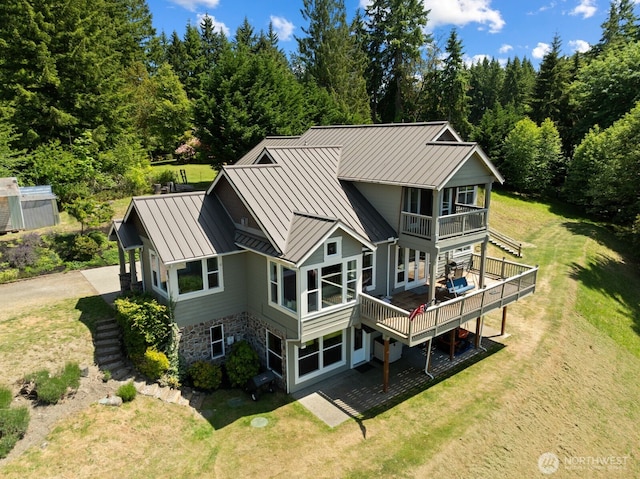 5675 E Hillcrest Dr, Port Orchard, WA 98366 - back of property featuring a standing seam roof, a balcony, a lawn, and metal roof