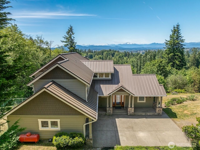 5675 E Hillcrest Dr, Port Orchard, WA 98366 - craftsman-style home featuring a porch, a view of trees, metal roof, and a mountain view