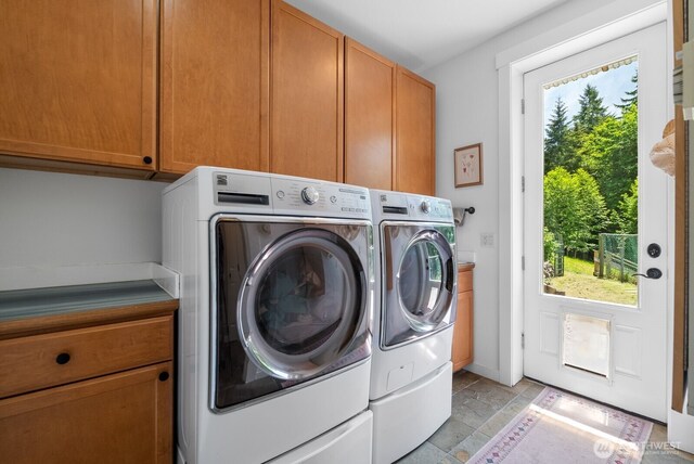 5675 E Hillcrest Dr, Port Orchard, WA 98366 - laundry area with washer and clothes dryer, cabinet space, and light stone finish flooring