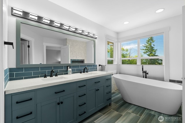 5675 E Hillcrest Dr, Port Orchard, WA 98366 - bathroom with double vanity, a soaking tub, decorative backsplash, and recessed lighting