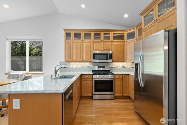 509 Clover Ln, Bellingham, WA 98226 - kitchen with stainless steel appliances, lofted ceiling, a sink, a peninsula, and light wood finished floors