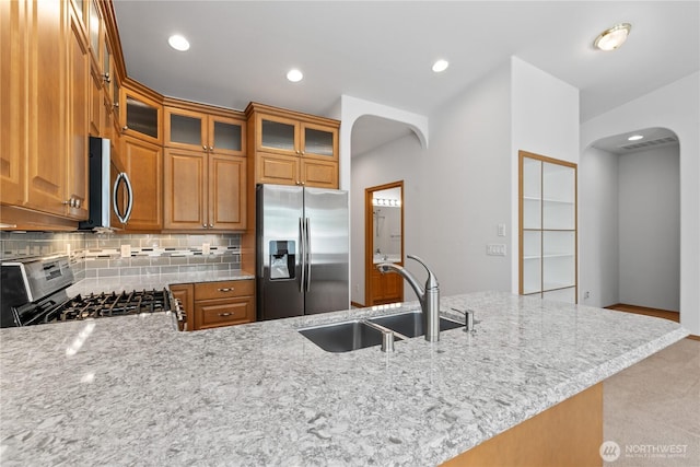 509 Clover Ln, Bellingham, WA 98226 - kitchen with appliances with stainless steel finishes, arched walkways, a sink, tasteful backsplash, and recessed lighting