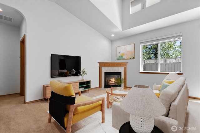 509 Clover Ln, Bellingham, WA 98226 - living room featuring a towering ceiling, light colored carpet, a fireplace, arched walkways, and recessed lighting