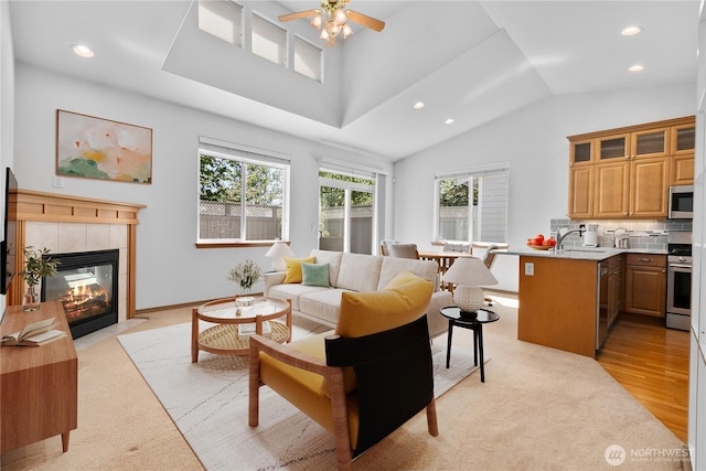 509 Clover Ln, Bellingham, WA 98226 - living area with recessed lighting, ceiling fan, vaulted ceiling, a fireplace, and light wood-type flooring