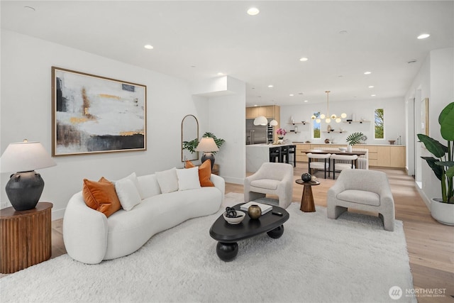 3973 162nd Pl SE, Bellevue, WA 98006 - living area with light wood-style flooring, recessed lighting, a chandelier, and baseboards
