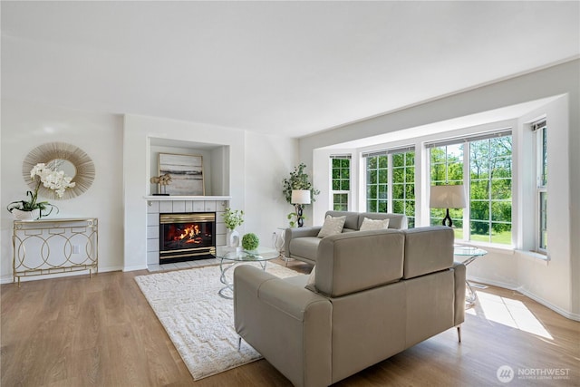 7718 NE 183rd St, Kenmore, WA 98028 - living area featuring wood finished floors, baseboards, and a fireplace
