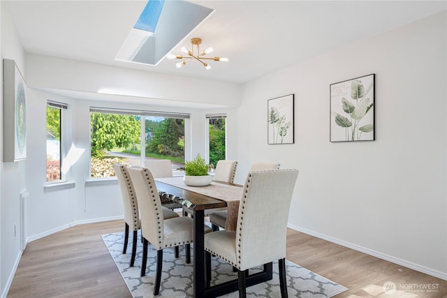 7718 NE 183rd St, Kenmore, WA 98028 - dining area featuring plenty of natural light, light wood finished floors, a chandelier, and baseboards