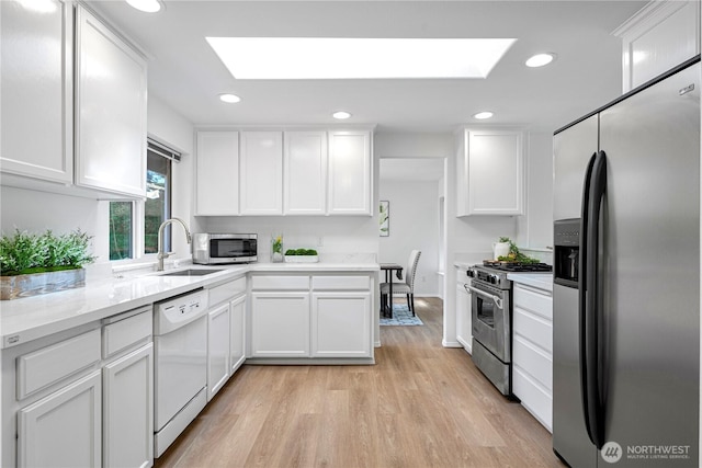 7718 NE 183rd St, Kenmore, WA 98028 - kitchen with stainless steel appliances, a skylight, white cabinetry, and recessed lighting