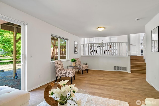 7718 NE 183rd St, Kenmore, WA 98028 - sitting room with light wood-style floors, baseboards, and stairway