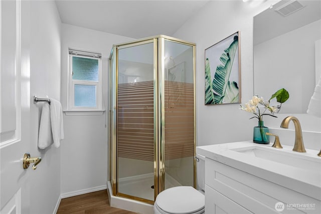 7718 NE 183rd St, Kenmore, WA 98028 - full bath with vanity, toilet, a stall shower, wood finished floors, and baseboards