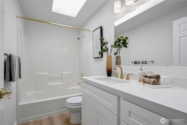 7718 NE 183rd St, Kenmore, WA 98028 - full bathroom with toilet, vanity, wood finished floors, shower / tub combination, and a skylight