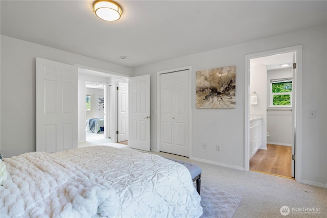 7718 NE 183rd St, Kenmore, WA 98028 - bedroom with light carpet, baseboards, ensuite bath, and a closet