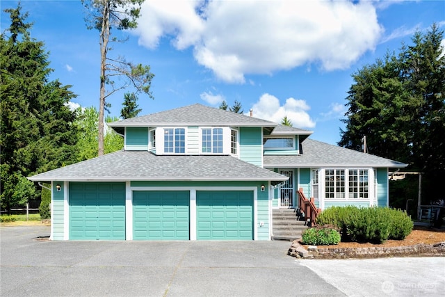 7718 NE 183rd St, Kenmore, WA 98028 - split level home featuring a shingled roof, an attached garage, and concrete driveway