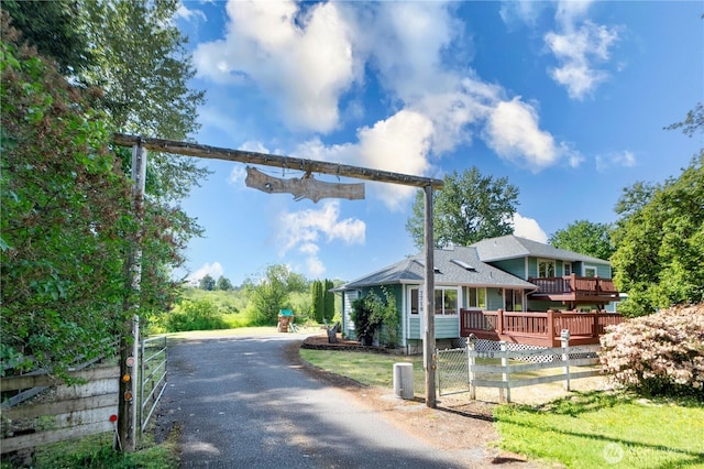 7718 NE 183rd St, Kenmore, WA 98028 - view of asphalt driveway featuring a gated entry
