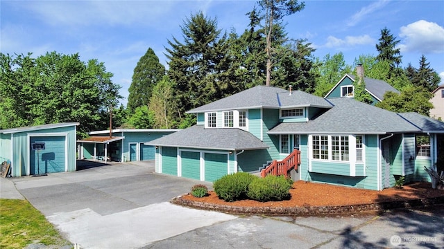 7718 NE 183rd St, Kenmore, WA 98028 - view of front of property with driveway, a shingled roof, and an outdoor structure