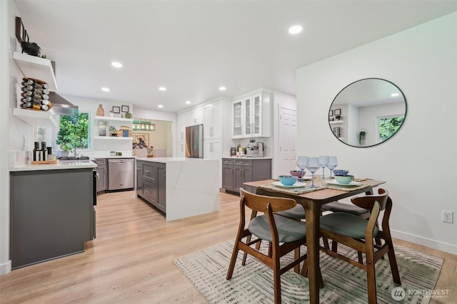 27716 NE 30th St, Redmond, WA 98053 - dining space featuring bar with sink, light wood-style flooring, recessed lighting, and baseboards