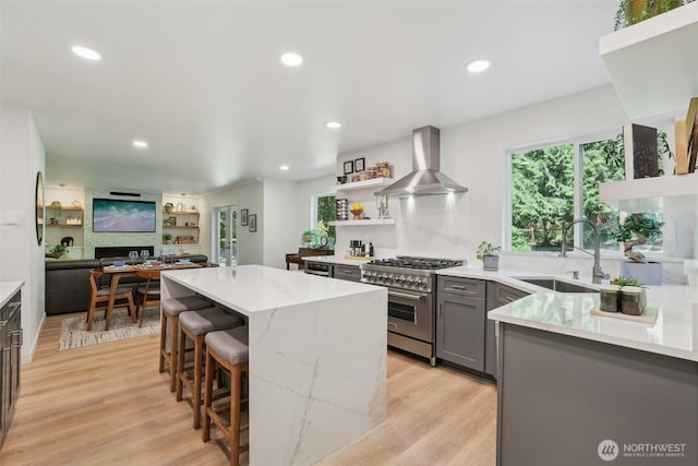 27716 NE 30th St, Redmond, WA 98053 - kitchen featuring high end range, wall chimney exhaust hood, a sink, gray cabinetry, and a center island