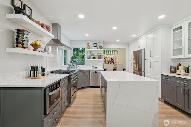 27716 NE 30th St, Redmond, WA 98053 - kitchen with open shelves, stainless steel appliances, wall chimney exhaust hood, gray cabinetry, and a kitchen island